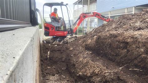 mini excavator digging along building perimeter|digging with mini excavators.